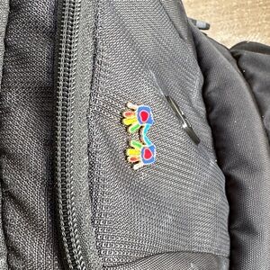 Gray Backpack with Colorful Pin